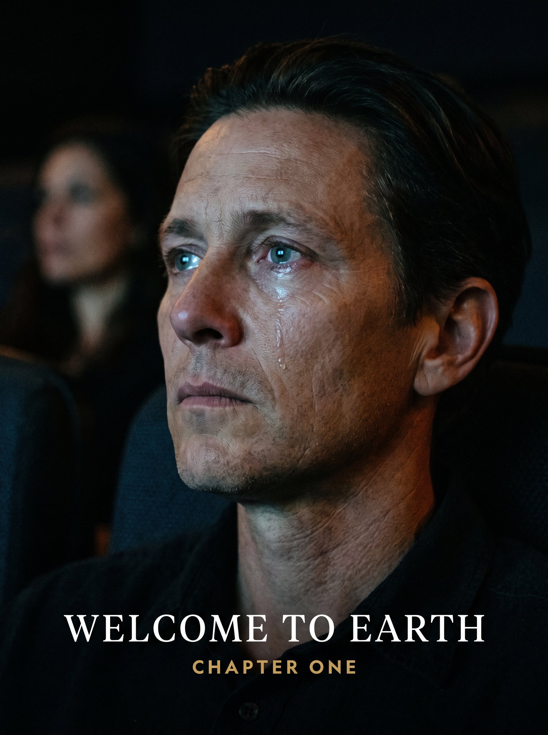 A single face in a darkened cinema, lit by the screen, one tear tracking down the cheek, under the title Welcome to Earth, Chapter One