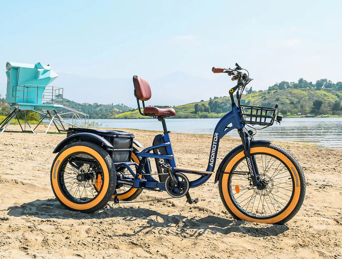 Addmotor Grandtan X in Neptune Blue parked on a sandy lakeshore, rear three-quarter view (Addmotor photo) — Zeus eBikes Canada