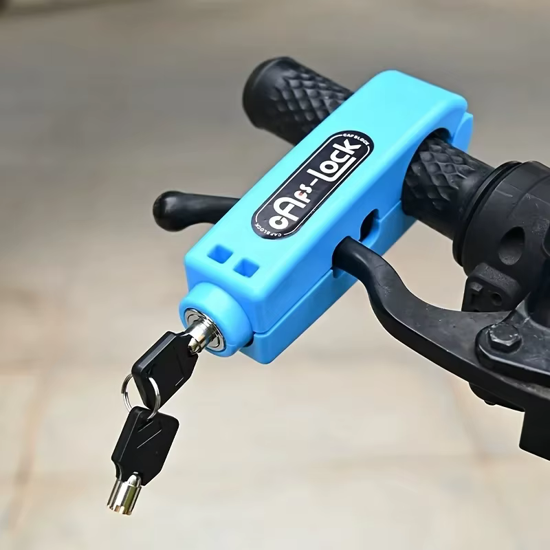 Blue grip lock closed over a handlebar grip and its brake lever, keys in the cylinder — Zeus eBikes Canada