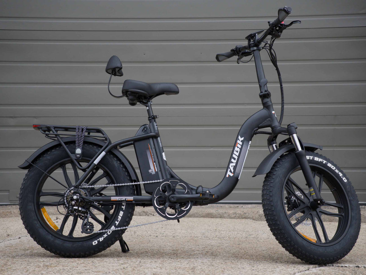 Taubik Escape S folding fat-tire e-bike in Matte Black, side view, with 20 x 4 inch CST BFT tires on mag wheels, rear rack and backrest saddle — Zeus eBikes Canada