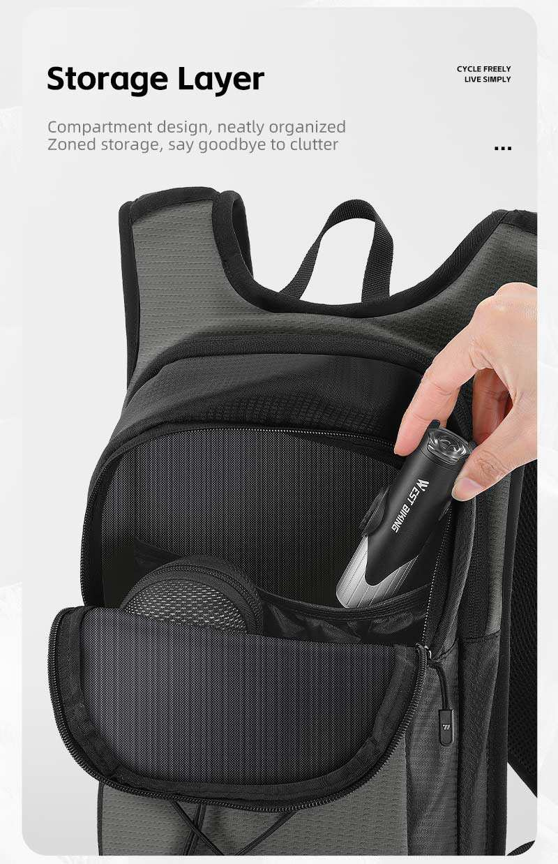 Supplier photo of the storage layer of the West Biking hydration backpack opened, with a hand placing an item inside — Zeus eBikes Canada