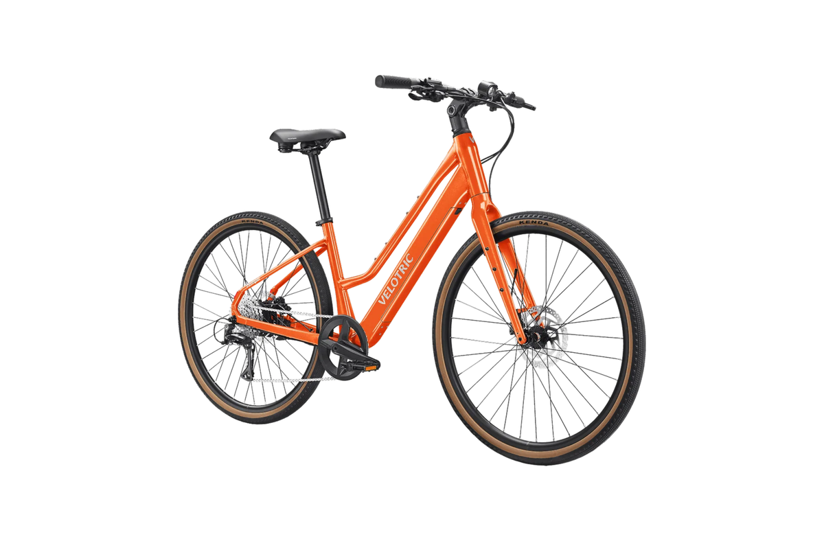 Velotric Tempo Mid-Step in Sunset Tangerine, three-quarter view — Zeus eBikes Canada