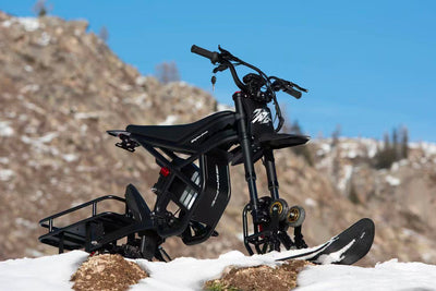 Riding Times GT54 fitted with the snow track kit on a snowy mountain landscape — Zeus eBikes Canada