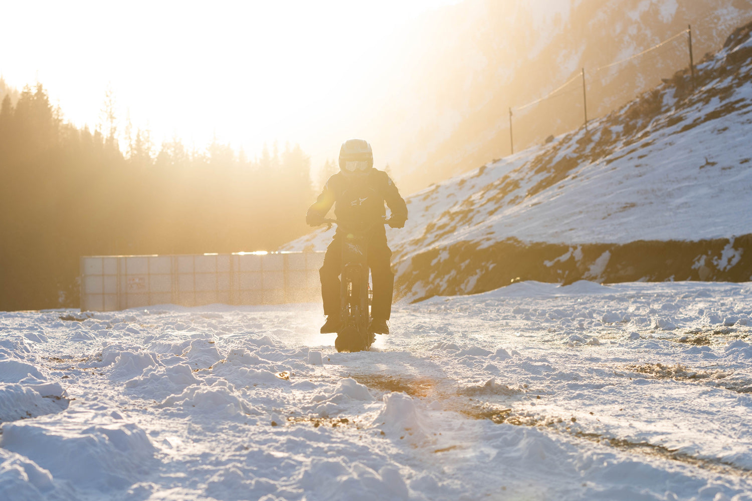 Rider on a track-converted Riding Times GT73 at sunset on deep snow — Zeus eBikes Canada