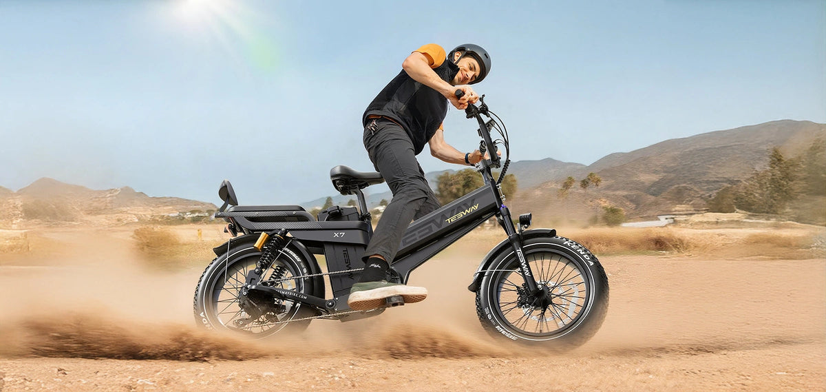 A helmeted rider throwing dust on a dirt track on the Tesway X7 Pro New in Black — Zeus eBikes Canada