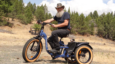 Rider on an Addmotor Grandtan X in Neptune Blue on a dry hillside with pine trees behind (Addmotor photo) — Zeus eBikes Canada