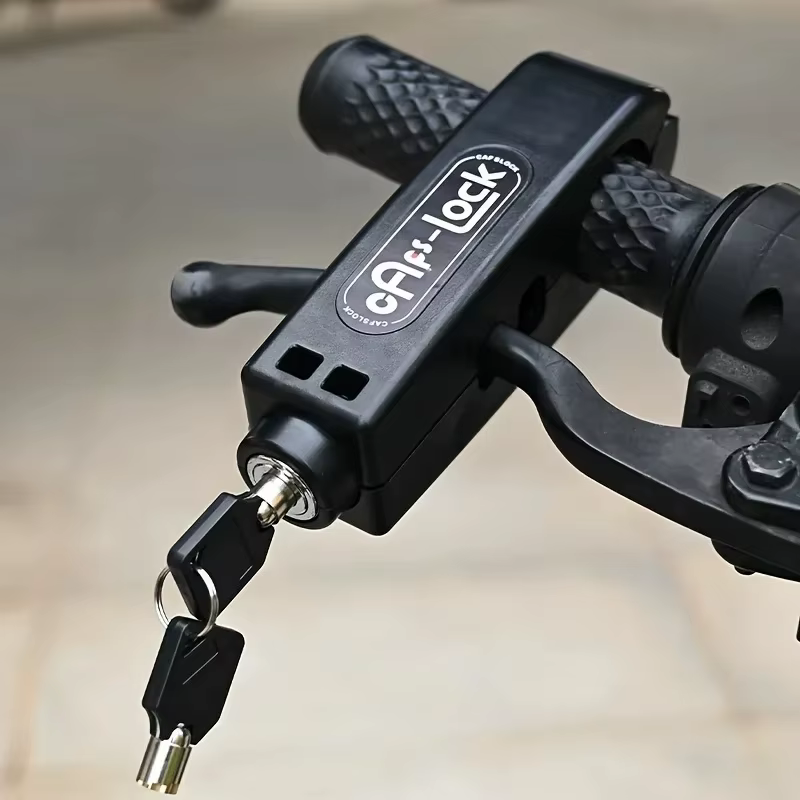 Black grip lock closed over a handlebar grip and its brake lever, two keys hanging from the cylinder — Zeus eBikes Canada