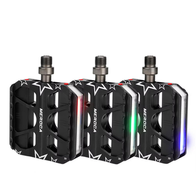 MEROCA light-up bike pedals shown glowing red, green and blue on a white background — Zeus eBikes Canada