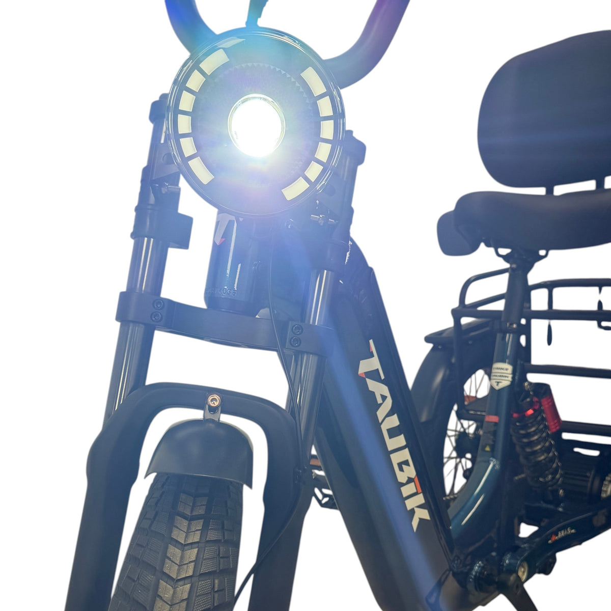 Taubik Axis headlight lit, with the backrest saddle behind, Gentian Blue frame (Taubik photo) — Zeus eBikes Canada
