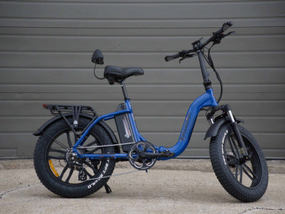 Taubik Escape S in Electric Blue, side view of the folding step-through frame on 20-inch mag wheels