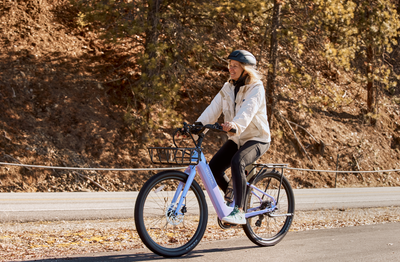 Rider on a Velotric Breeze 1 in Violet Haze with the optional front basket and rear rack, sold separately (Velotric photo) — Zeus eBikes Canada