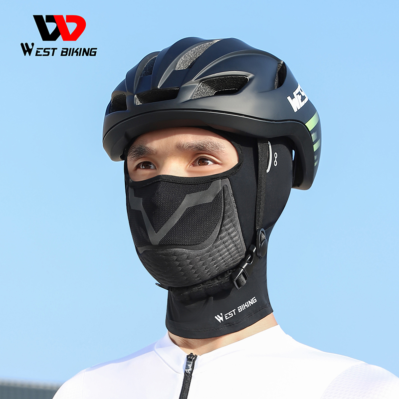 Rider wearing the long West Biking balaclava under a black cycling helmet, mesh mouth panel and textured chin section visible — Zeus eBikes Canada