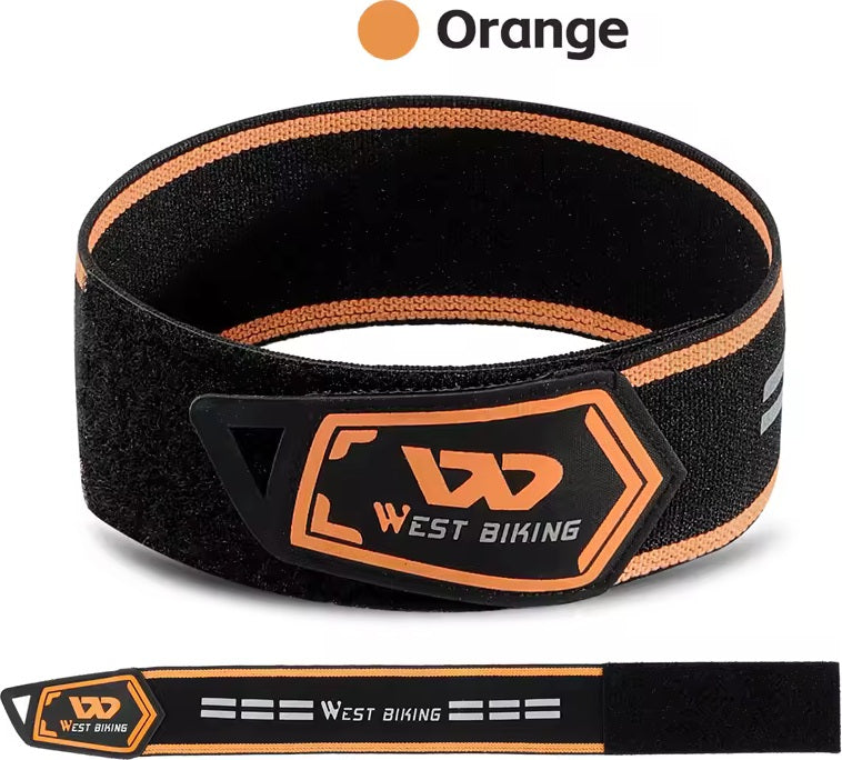 Black reflective ankle strap with orange accent, shown looped and laid flat